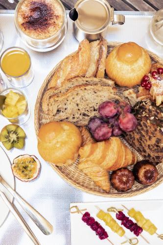 a plate of bread and pastries on a table at Villas Foch Boutique Hotel & Spa Bordeaux in Bordeaux