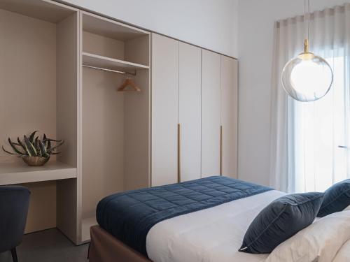 a bedroom with a bed and a desk and a window at Living u HomeSuites in Lecce
