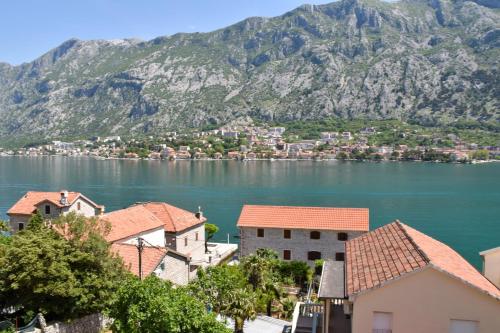 a view of a town on the water with mountains at Apartments Simun in Kotor