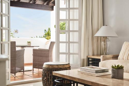 a living room with a couch and a table at Puente Romano Marbella in Marbella