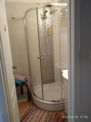 a shower with a glass door in a bathroom at Studio Apartman Marti in Kostrena