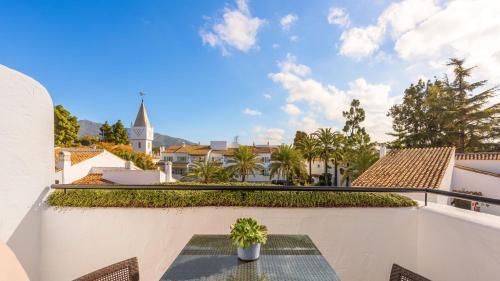a potted plant sitting on a table on a balcony at Puente Romano Marbella in Marbella