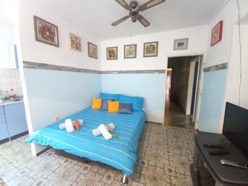 a bedroom with a blue bed with pillows on it at Apartments Lorinda in Mošćenička Draga