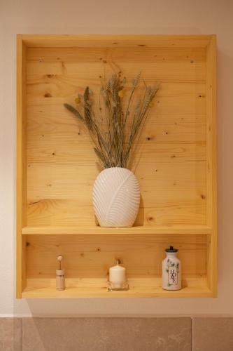 a wooden shelf with a vase on top of it at PRIVILLAGE Stare - Villa & Chalet in Bohinj