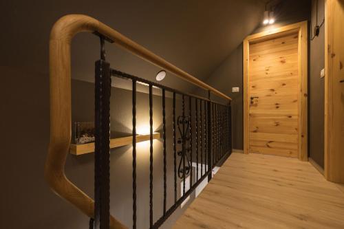 a staircase with a wooden railing and a wooden door at PRIVILLAGE Stare - Villa & Chalet in Bohinj