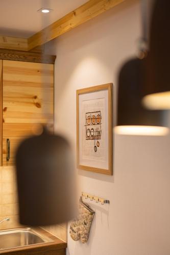 a kitchen with a framed picture on the wall at PRIVILLAGE Stare - Villa & Chalet in Bohinj
