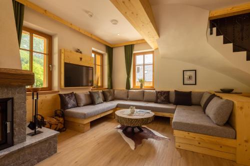 a living room with a couch and a table at PRIVILLAGE Stare - Villa & Chalet in Bohinj