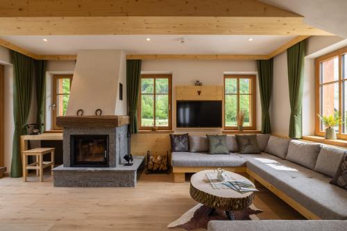 a living room with a couch and a fireplace at PRIVILLAGE Stare - Villa & Chalet in Bohinj