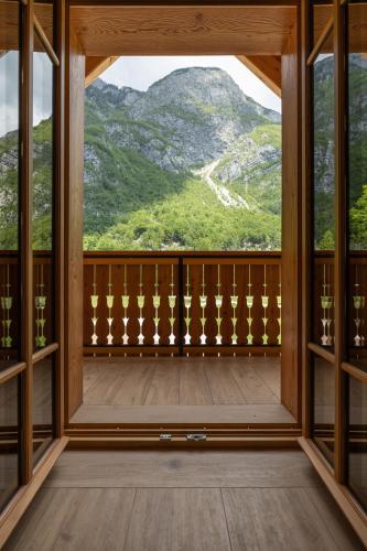a room with a view of mountains from a window at PRIVILLAGE Stare - Villa & Chalet in Bohinj