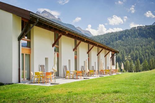 a row of chairs and tables outside of a building at Reka-Ferienanlage Scuol in Scuol
