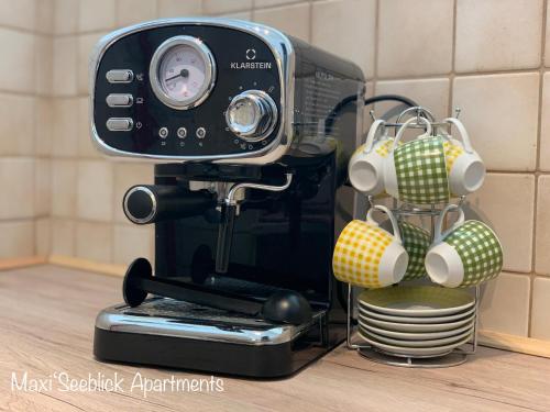 a coffee maker sitting on top of a counter at Maxi'Seeblick Apartments in Seeboden