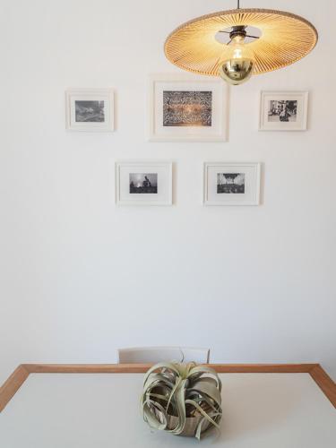 a room with a ceiling fan and pictures on the wall at Living u HomeSuites in Lecce