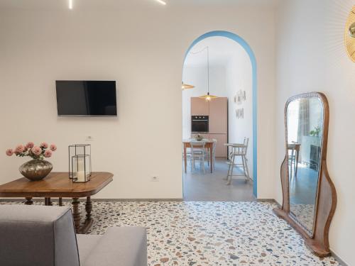 a living room with a mirror and a table at Living u HomeSuites in Lecce