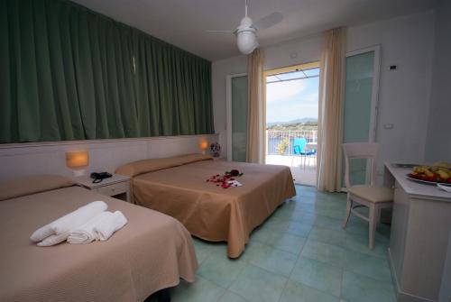 Postel nebo postele na pokoji v ubytování Hotel Dino
