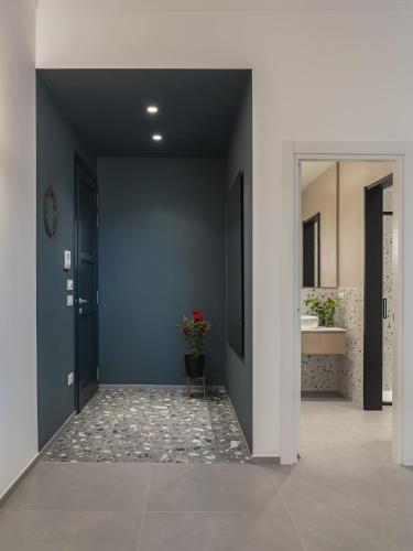a hallway with a bathroom with a sink and a mirror at Living u HomeSuites in Lecce