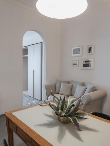 a living room with a couch and a table at Living u HomeSuites in Lecce