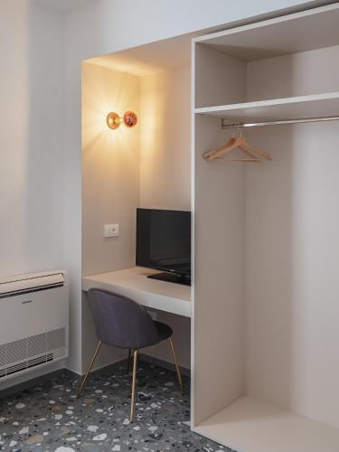 a room with a desk with a computer and a chair at Living u HomeSuites in Lecce