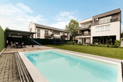 a swimming pool in the backyard of a house at OAK Residents Siófok in Siófok