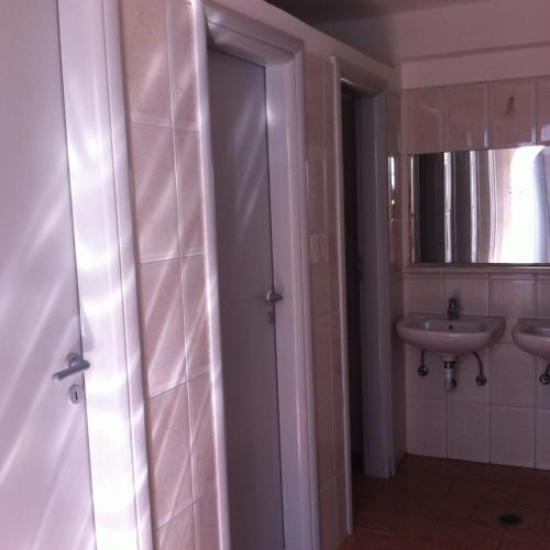 a bathroom with a sink and a mirror at Plaka Camping Naxos in Plaka
