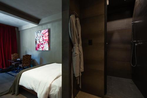a bedroom with a bed and a shower in it at Casa Malca in Tulum