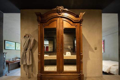 a large wooden cabinet in a room with a sink at Casa Malca in Tulum
