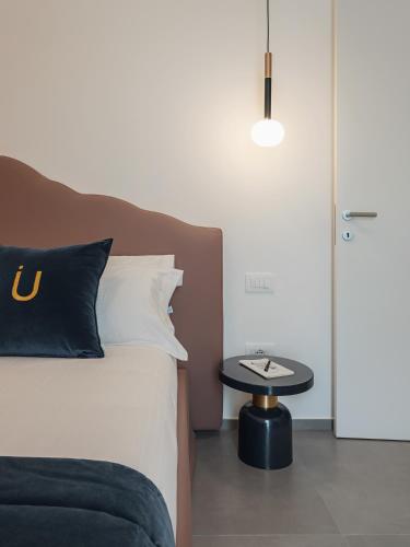 a bedroom with a bed and a side table at Living u HomeSuites in Lecce