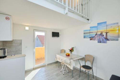 a kitchen and dining room with a table and chairs at Dora&Paulo sweet countryside cottage in Babino Polje