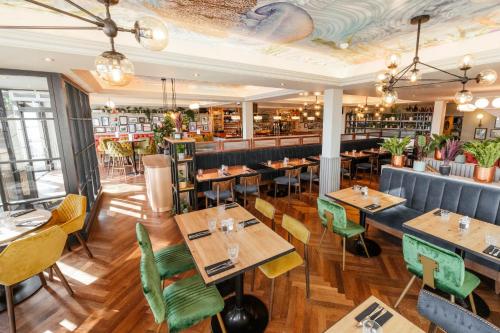 un restaurante con mesas y sillas de madera y un bar en Oyster House, en Mumbles