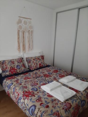 a bed in a room with two plates on it at Casa do Xico in Ponte de Lima