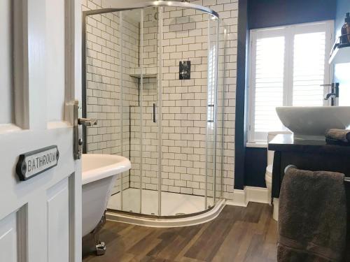 a bathroom with a glass shower and a sink at Emerson House 2Bed Sleeps 6 EV Point Dog Friendly Parking Groups Families Professionals in Poole