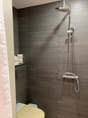 a bathroom with a toilet and a shower at Apartamentos Mar-Bel Sol in Vilamoura