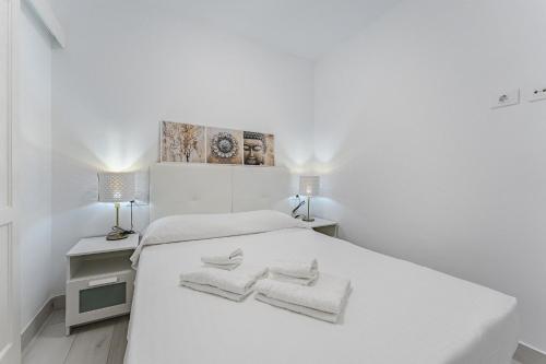 a white bedroom with two towels on a bed at 303. MODERN, SUNNY IFONCHE WITH WiFi in Adeje
