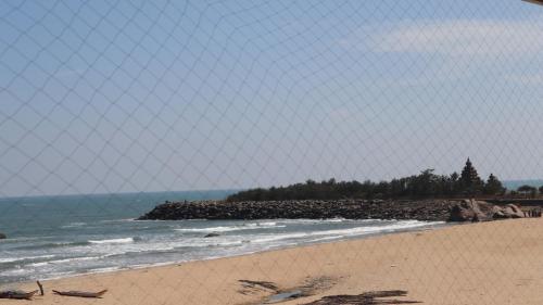 a view of the beach from behind a fence at Holiday Inn Express Chennai OMR Thoraipakkam by IHG in Chennai
