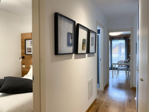 a bedroom with four pictures on the wall at Great Escapes in Ponte di Legno