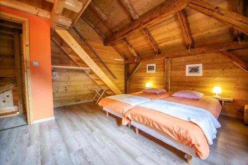 タナンジュにあるGite Le Relaisのログキャビン内のベッドルーム1室(ベッド2台付)