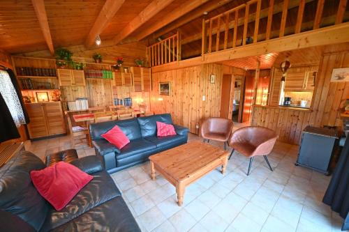 a living room with a couch and a table at River View in Rendeux