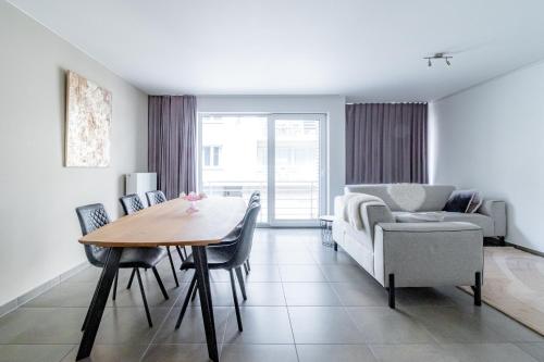 a living room with a table and a couch at Laluna holiday apartment in Ostend