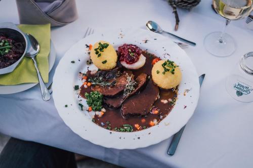 a plate of food with meat and biscuits on a table at Landhotel Spessartruh in Frammersbach