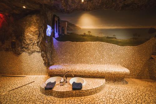 a bathroom with a sink in a stone wall at Landhotel Spessartruh in Frammersbach