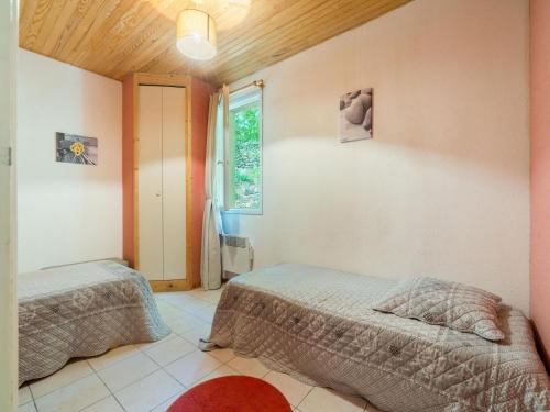 a bedroom with two beds and a window at Family Escape in Les Salelles in Chambonas