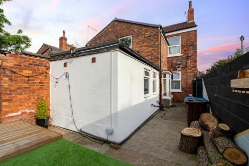 a white shed in the backyard of a house at Stunning Victorian House in Hull
