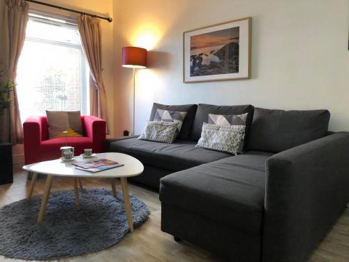 a living room with a couch and a table at City Centre - Parking - Great Location - 4 Beds in Belfast