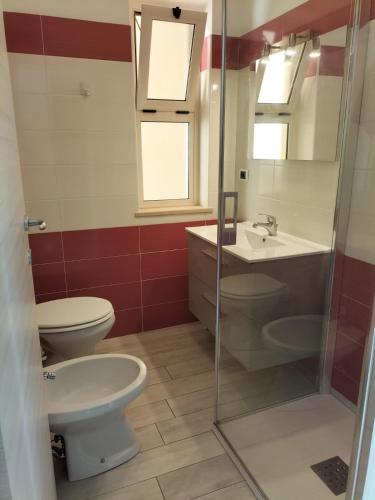 a bathroom with a toilet and a sink at ZAMBRONE VILLAGE Loris in Zambrone