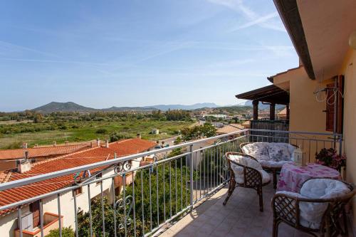 a balcony with two chairs and a table at Prenda Home Holiday in Posada