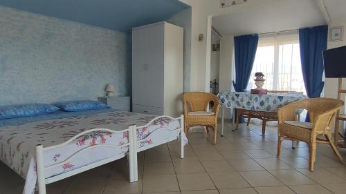 a bedroom with a bed and a table and chairs at Suite CielAzzurro in Arezzo