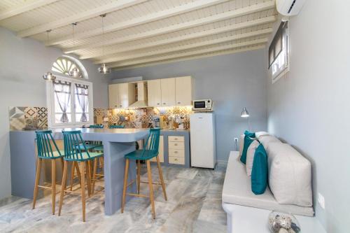 a kitchen and living room with a table and chairs at Θἔρως (Theros) house 3- Agios Fokas in Agios Sostis