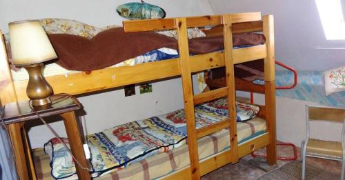 two bunk beds in a room with a lamp at Maison de 3 chambres avec jardin clos a Teyssieu in Teyssieu