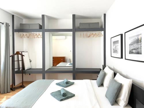 a bedroom with a large bed with two pillows on it at Villas Pedroso: nature, mountains and the ocean in Cascais