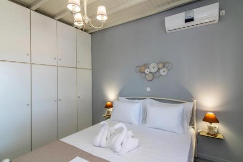 a bedroom with a bed with towels on it at Θἔρως (Theros) house 3- Agios Fokas in Agios Sostis