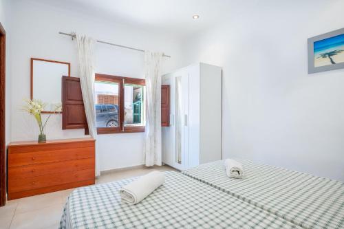 a bedroom with two twin beds and a window at Villa Caldentey in Ariany